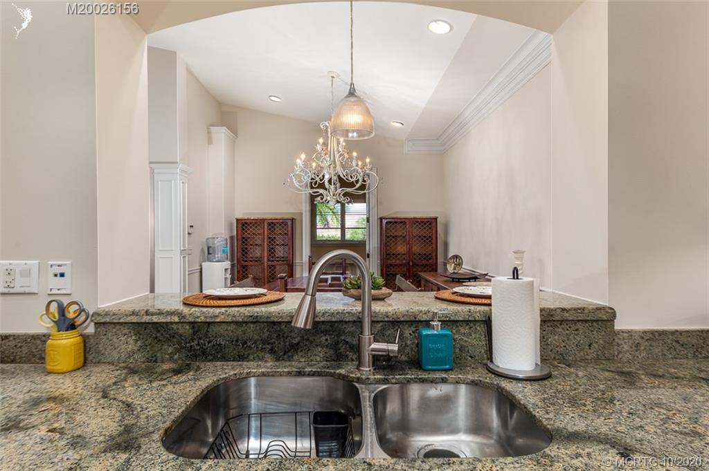 982 Southeast Willoughby Trace, Unit 15 Stuart, FL 34997 - Photo 16 of 36 a kitchen with sink and a granite counter top
