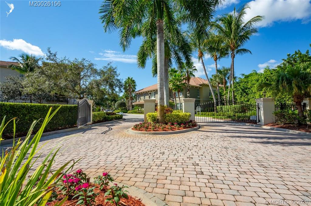 982 Southeast Willoughby Trace, Unit 15 Stuart, FL 34997 - Photo 2 of 36 a view of a backyard with plants and palm trees