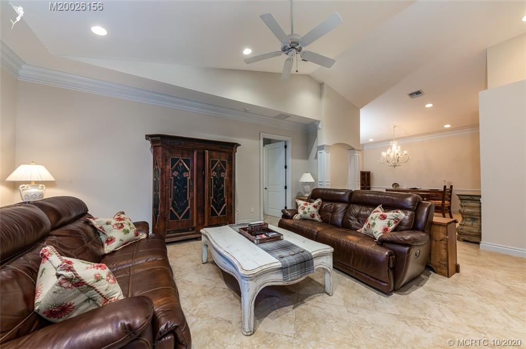 982 Southeast Willoughby Trace, Unit 15 Stuart, FL 34997 - Photo 6 of 36 a living room with furniture and a ceiling fan