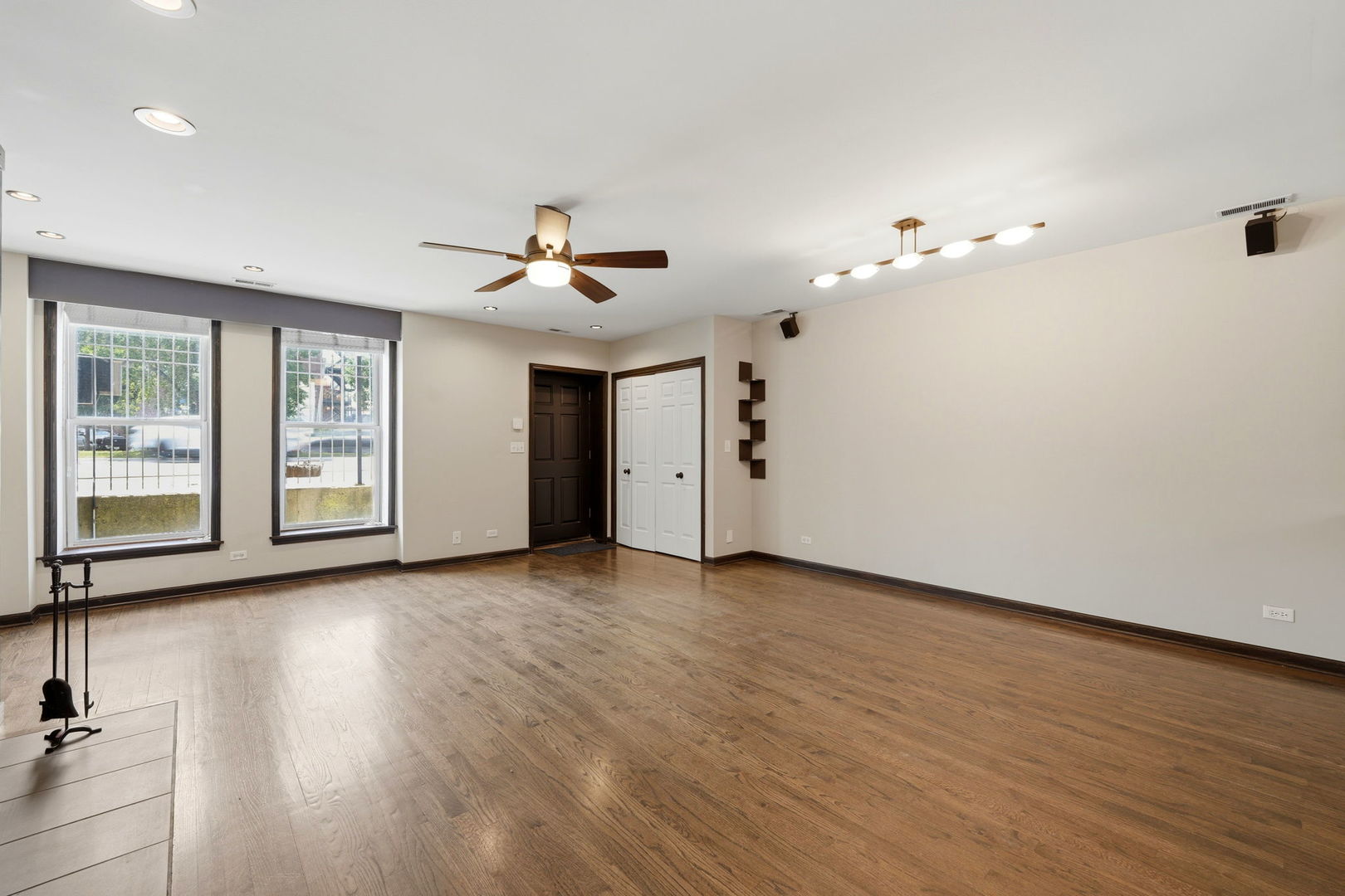 619 North Racine Avenue, Unit 1 Chicago, IL 60642 - Photo 13 of 36 a view of an empty room with a window and wooden floor