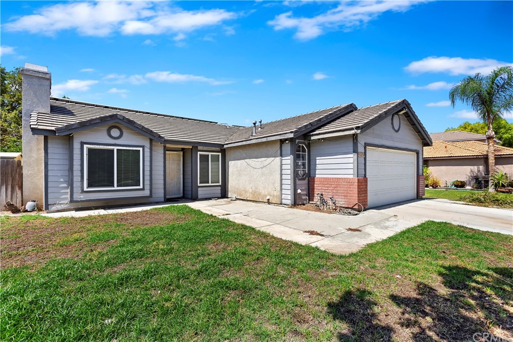 4512 Wabash Court Riverside, CA 92501 - Photo 1 of 1 a front view of a house with a garden and yard
