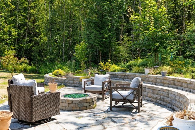 a view of a chairs and table in backyard