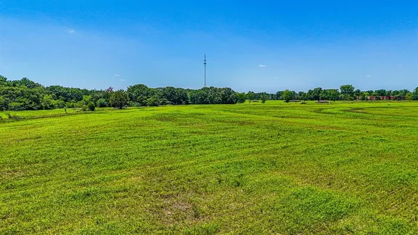 a view of a field with an trees