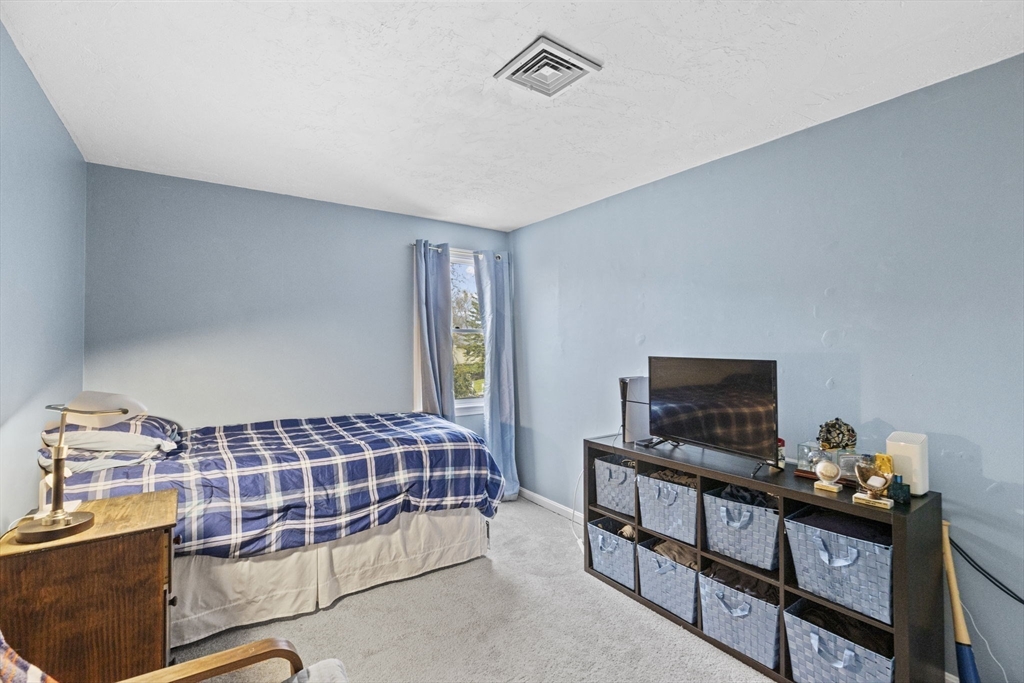 3 Marion Road Scituate, MA 02066 - Photo 19 of 30 a bedroom with a bed and flat tv screen on the dresser