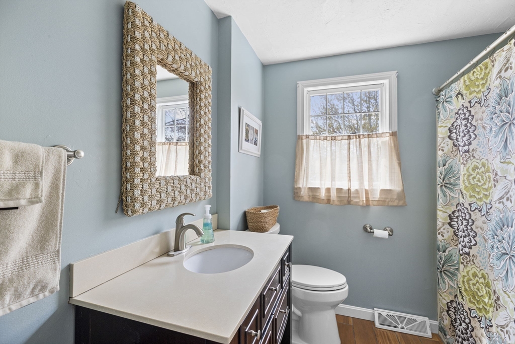 3 Marion Road Scituate, MA 02066 - Photo 25 of 30 a bathroom with a sink a toilet and a window