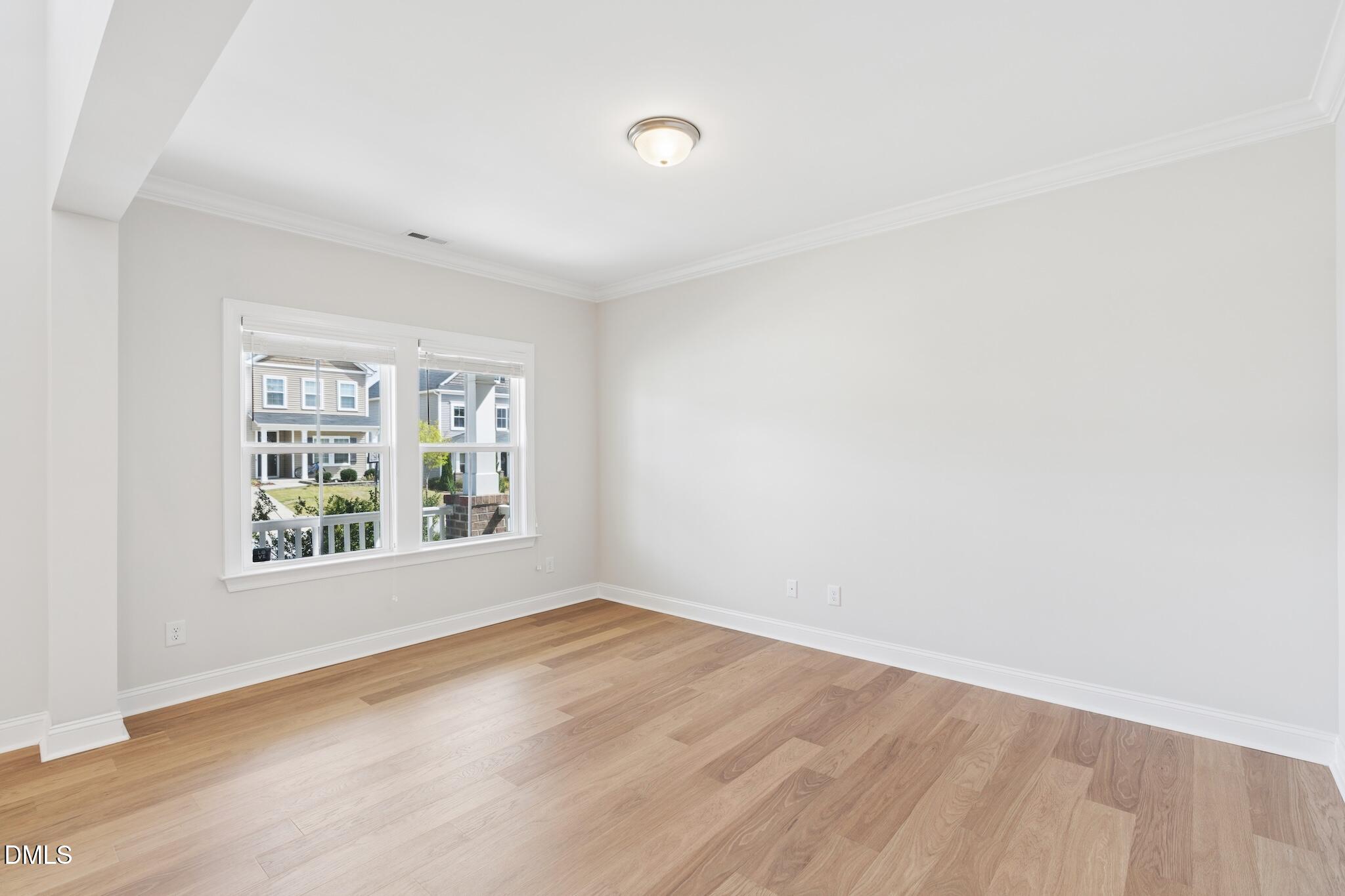 2616 Nordmann Fir Road Raleigh, NC 27616 - Photo 12 of 53 an empty room with wooden floor and windows