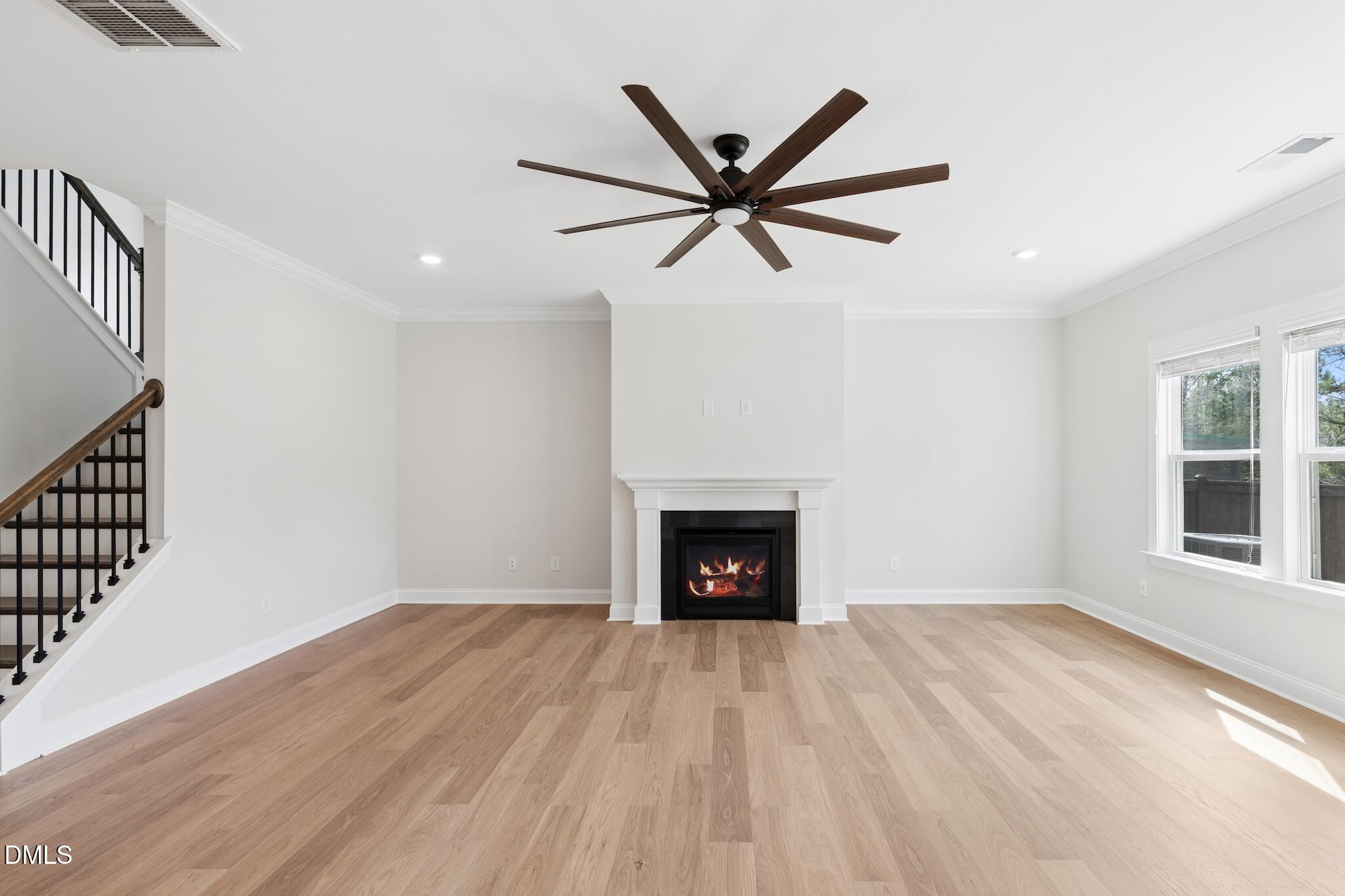 2616 Nordmann Fir Road Raleigh, NC 27616 - Photo 13 of 53 a view of a livingroom with a fireplace and wooden floor