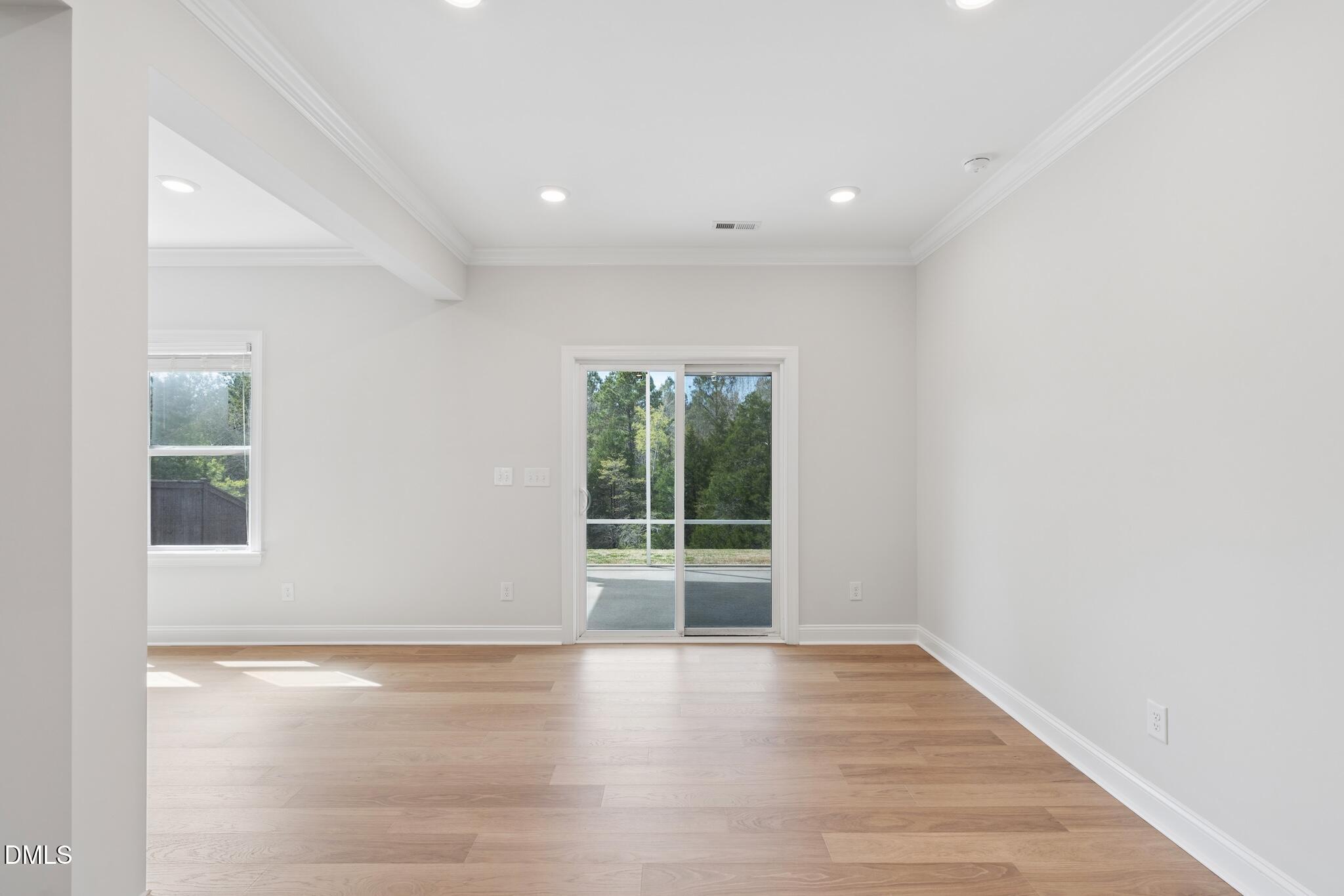 2616 Nordmann Fir Road Raleigh, NC 27616 - Photo 16 of 53 a view of an empty room with wooden floor and a window