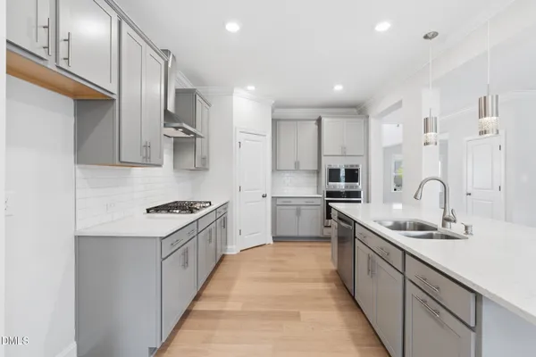 a kitchen with granite countertop white cabinets and stainless steel appliances