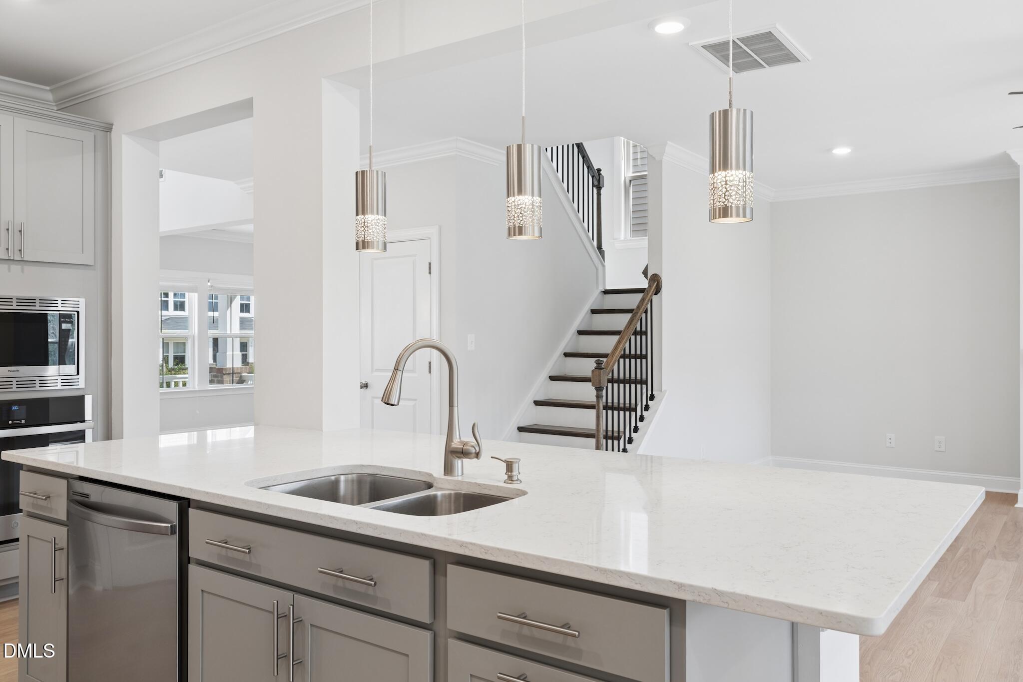 2616 Nordmann Fir Road Raleigh, NC 27616 - Photo 22 of 53 a kitchen with sink and white cabinets with wooden floor