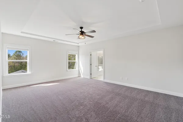 a view of a livingroom with a ceiling fan and window