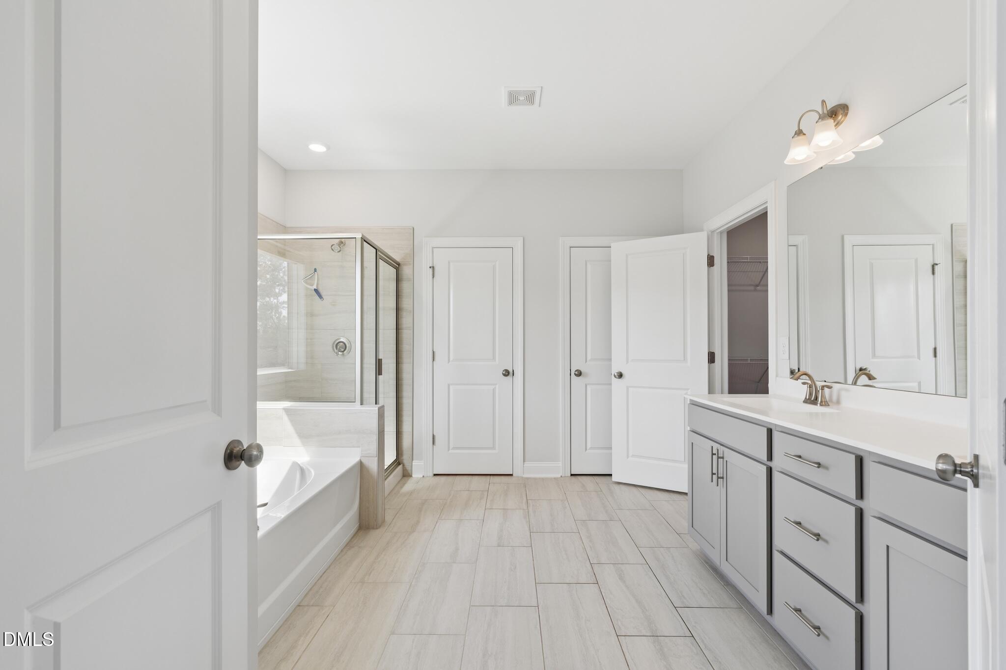 2616 Nordmann Fir Road Raleigh, NC 27616 - Photo 34 of 53 a bathroom with a tub shower sink vanity granite and a mirror