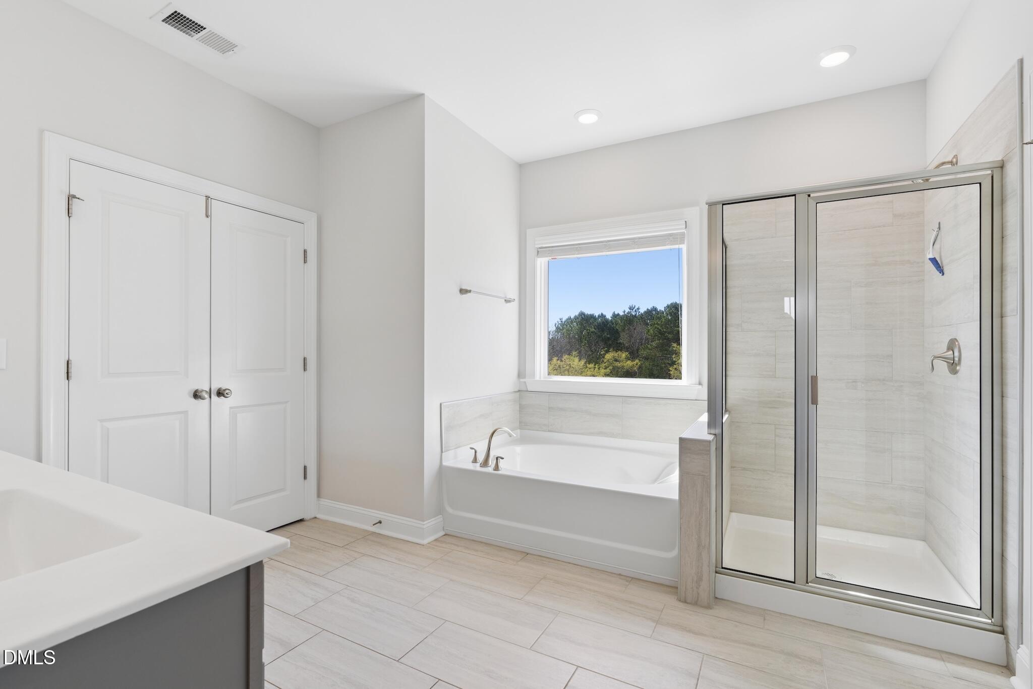 2616 Nordmann Fir Road Raleigh, NC 27616 - Photo 35 of 53 a bathroom with a bathtub and a shower