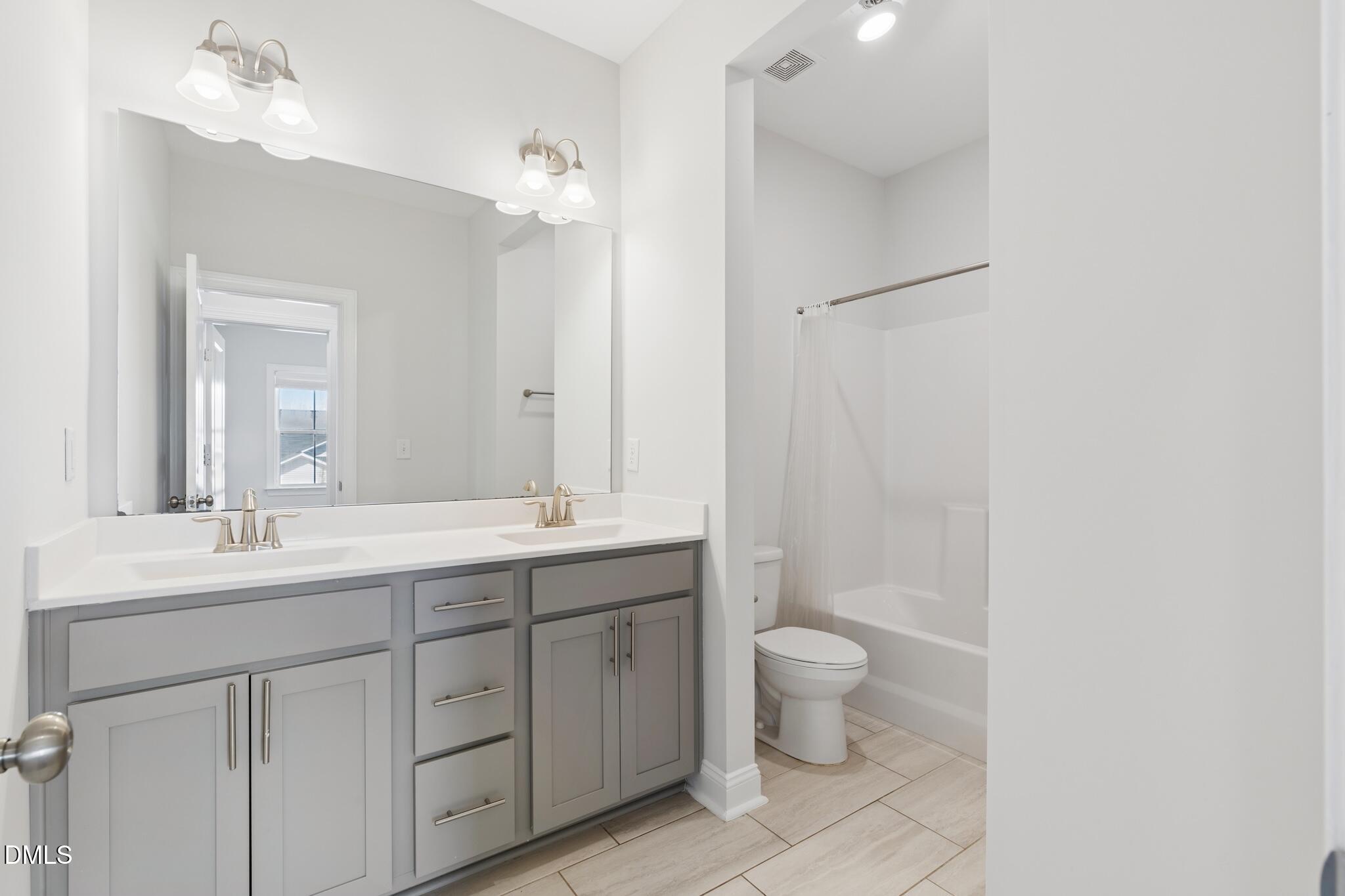2616 Nordmann Fir Road Raleigh, NC 27616 - Photo 39 of 53 a spacious bathroom with a double vanity sink toilet and a mirror