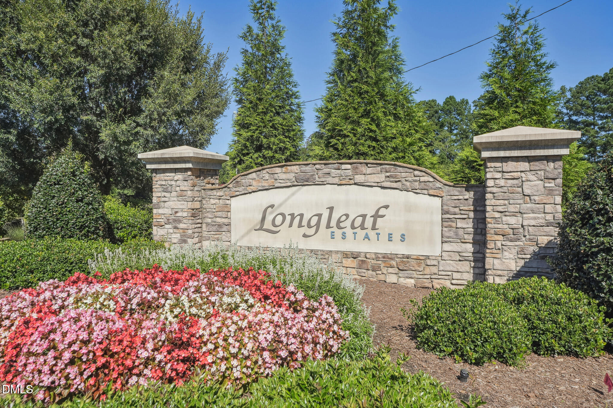 2616 Nordmann Fir Road Raleigh, NC 27616 - Photo 49 of 53 a sign that is sitting in front of flowers