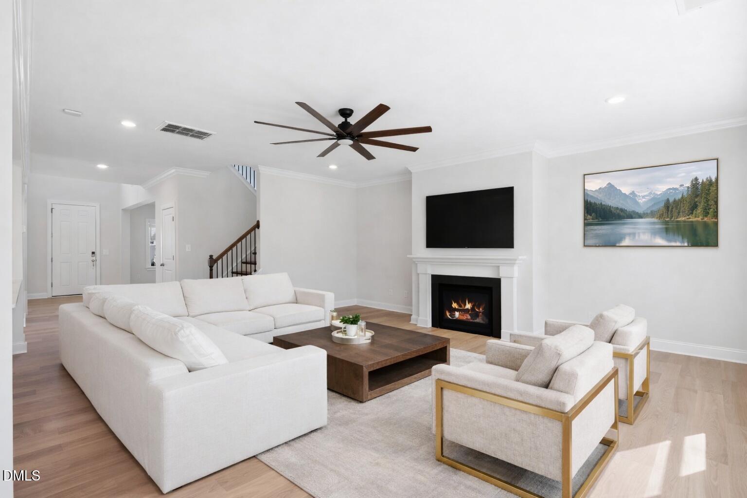 2616 Nordmann Fir Road Raleigh, NC 27616 - Photo 4 of 53 a living room with furniture a fireplace and a flat screen tv