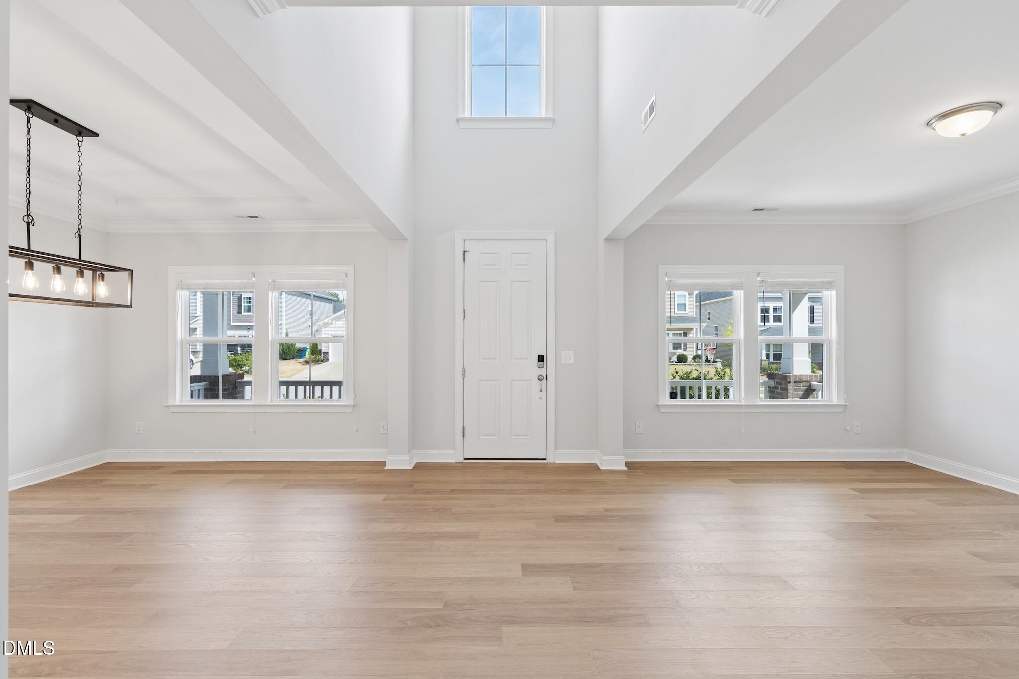 2616 Nordmann Fir Road Raleigh, NC 27616 - Photo 9 of 53 an empty room with wooden floor and windows