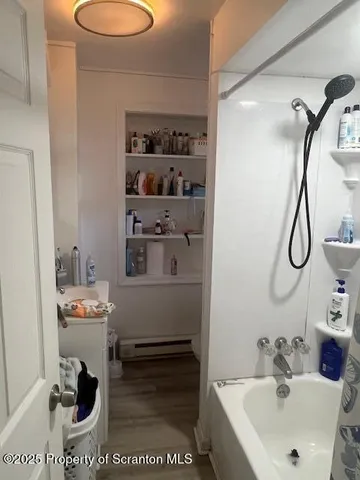 a bathroom with a toilet and shower curtain
