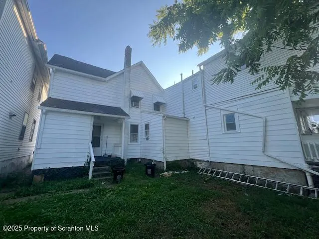 a kitchen with sink a refrigerator and cabinets