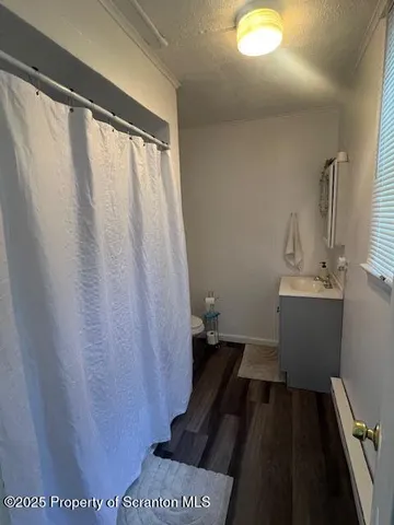 a bathroom with a sink and mirror with toilet