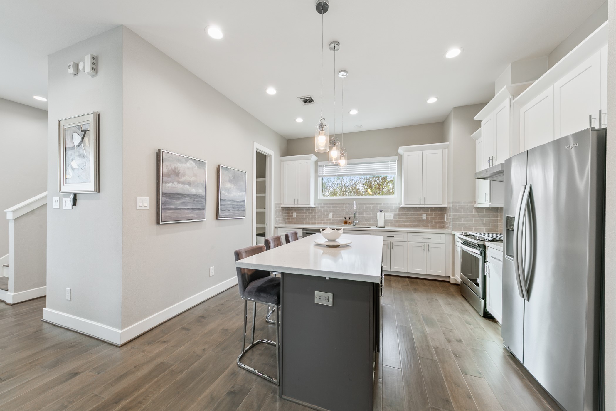 4032 Buck Street, Unit A Houston, TX 77020 - Photo 16 of 39 a kitchen with refrigerator cabinets and wooden floor