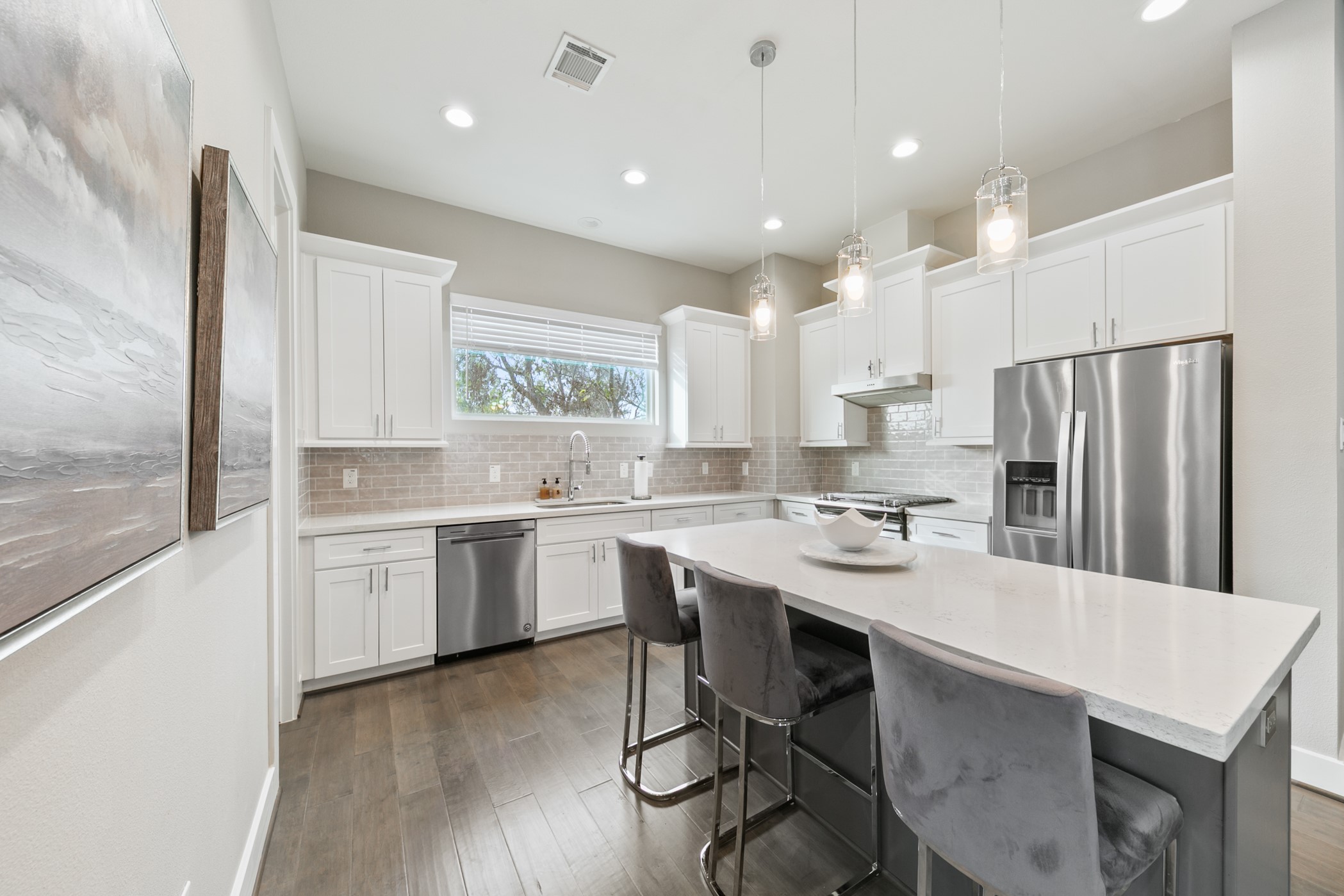 4032 Buck Street, Unit A Houston, TX 77020 - Photo 17 of 39 a kitchen with white cabinets and stainless steel appliances