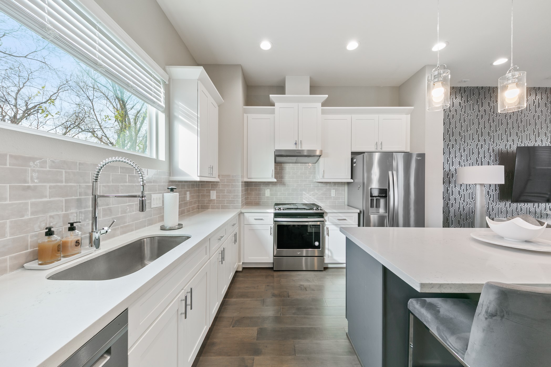 4032 Buck Street, Unit A Houston, TX 77020 - Photo 18 of 39 a large kitchen with stainless steel appliances kitchen island granite countertop a sink refrigerator and cabinets