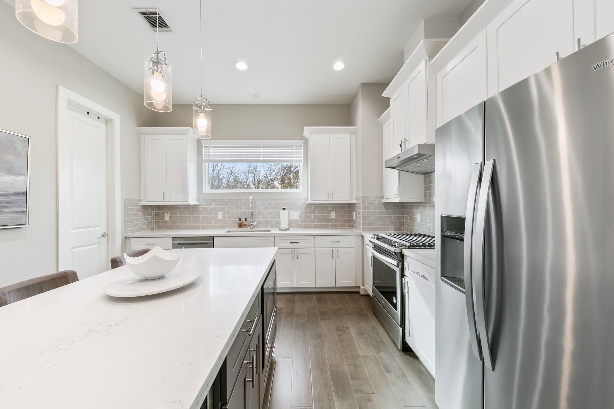 4032 Buck Street, Unit A Houston, TX 77020 - Photo 21 of 39 a kitchen with white cabinets and stainless steel appliances