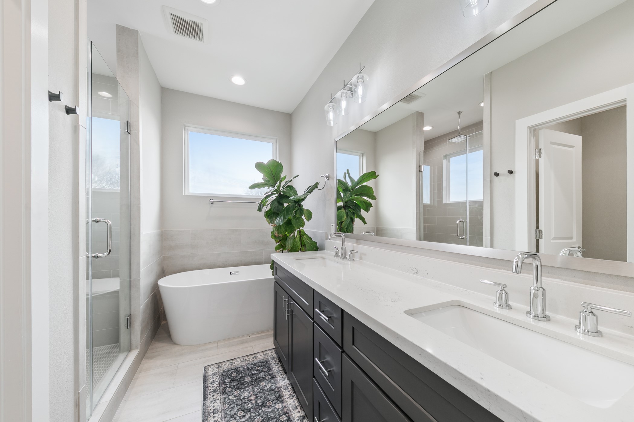 4032 Buck Street, Unit A Houston, TX 77020 - Photo 27 of 39 a bathroom with a double vanity sink toilet and shower