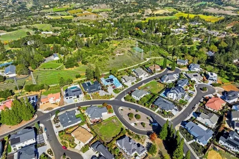 an aerial view of a residential apartment building with a yard