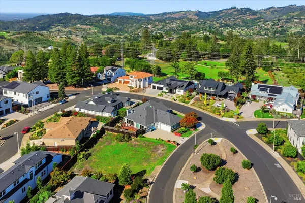 an aerial view of a house with a swimming pool yard and mountain view in back