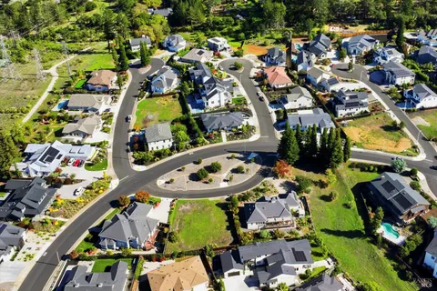 an aerial view of residential houses with outdoor space