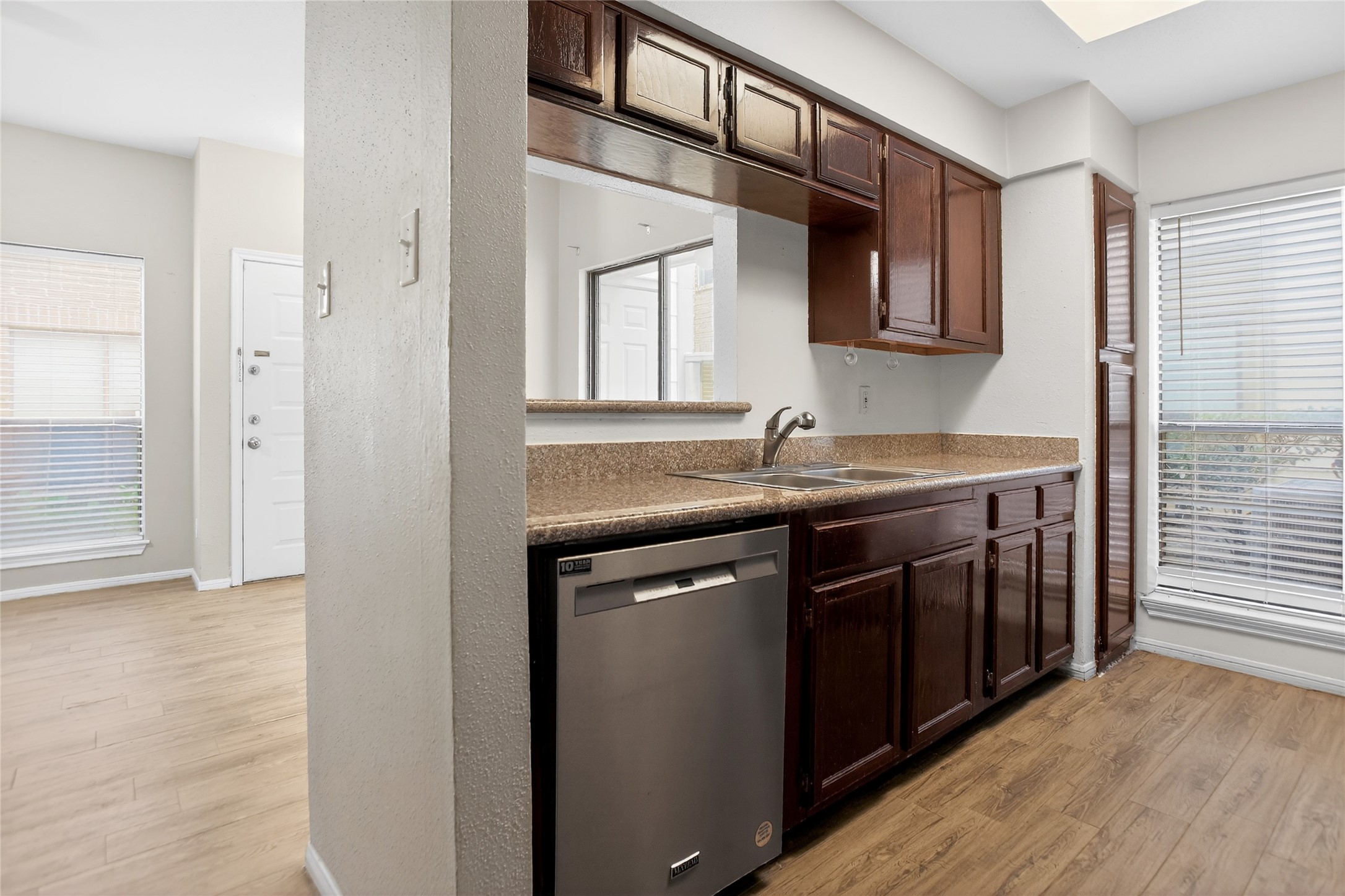 8299 Cambridge Street, Unit 706 Houston, TX 77054 - Photo 11 of 30 a kitchen with stainless steel appliances granite countertop a sink and cabinets with wooden floor