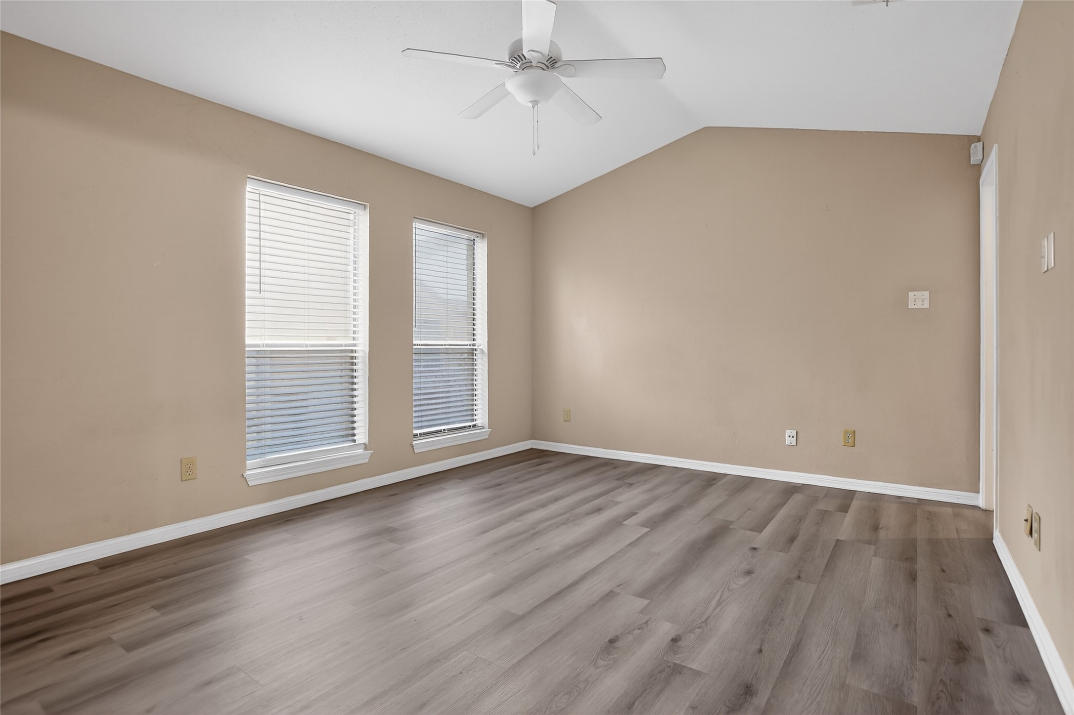 8299 Cambridge Street, Unit 706 Houston, TX 77054 - Photo 13 of 30 an empty room with wooden floor chandelier fan and windows