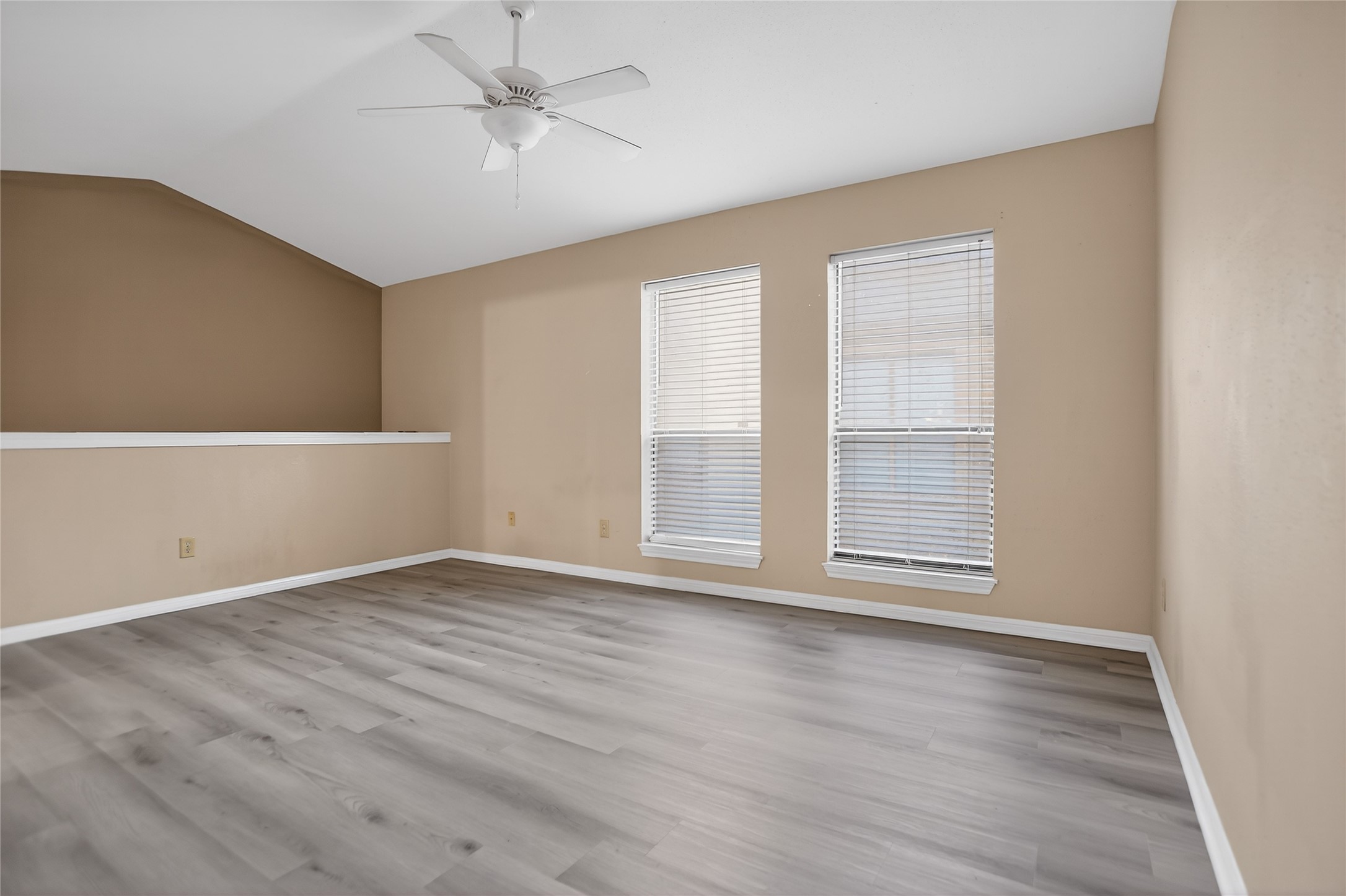 8299 Cambridge Street, Unit 706 Houston, TX 77054 - Photo 16 of 30 an empty room with wooden floor cabinet and windows