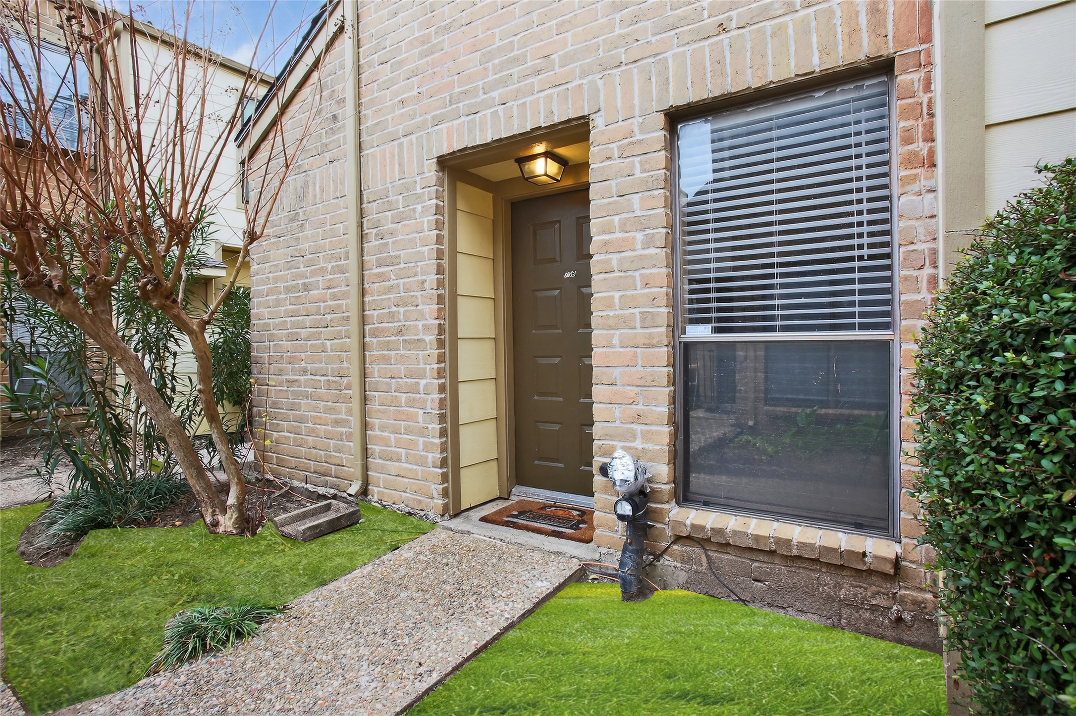 8299 Cambridge Street, Unit 706 Houston, TX 77054 - Photo 2 of 30 a front view of a house with garden