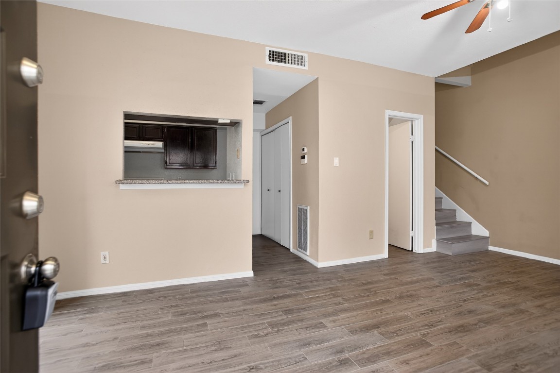 8299 Cambridge Street, Unit 706 Houston, TX 77054 - Photo 22 of 30 an empty room with wooden floor and way to kitchen