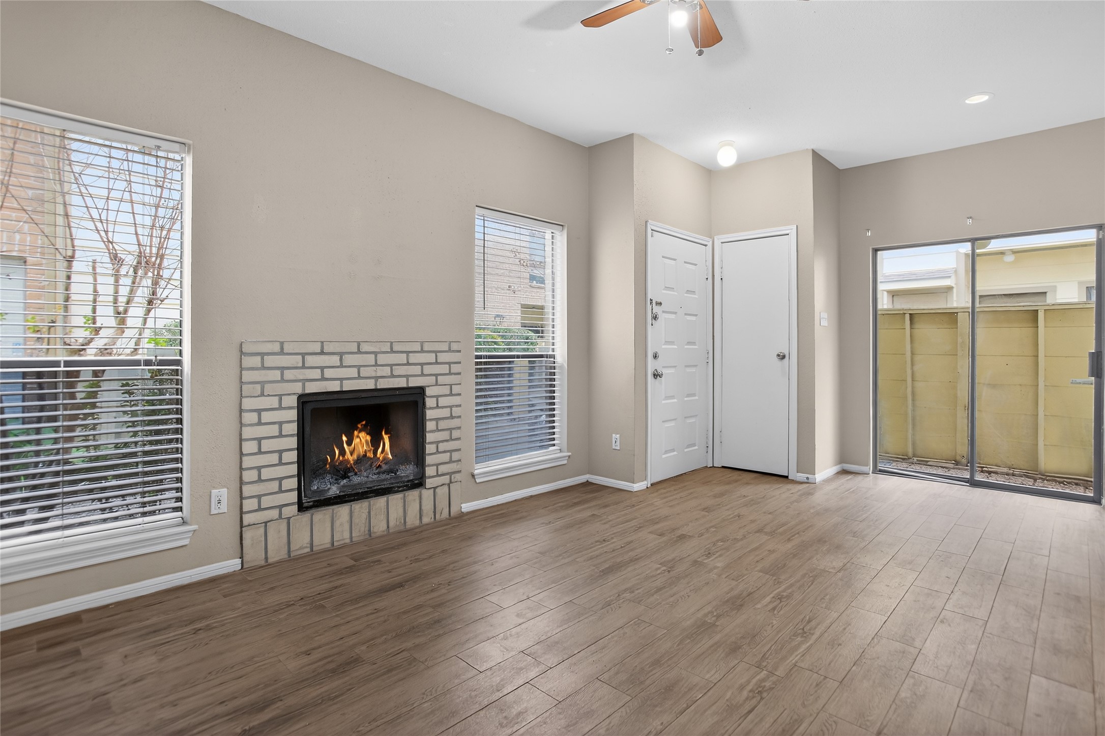 8299 Cambridge Street, Unit 706 Houston, TX 77054 - Photo 5 of 30 a view of an empty room with wooden floor fireplace and a window