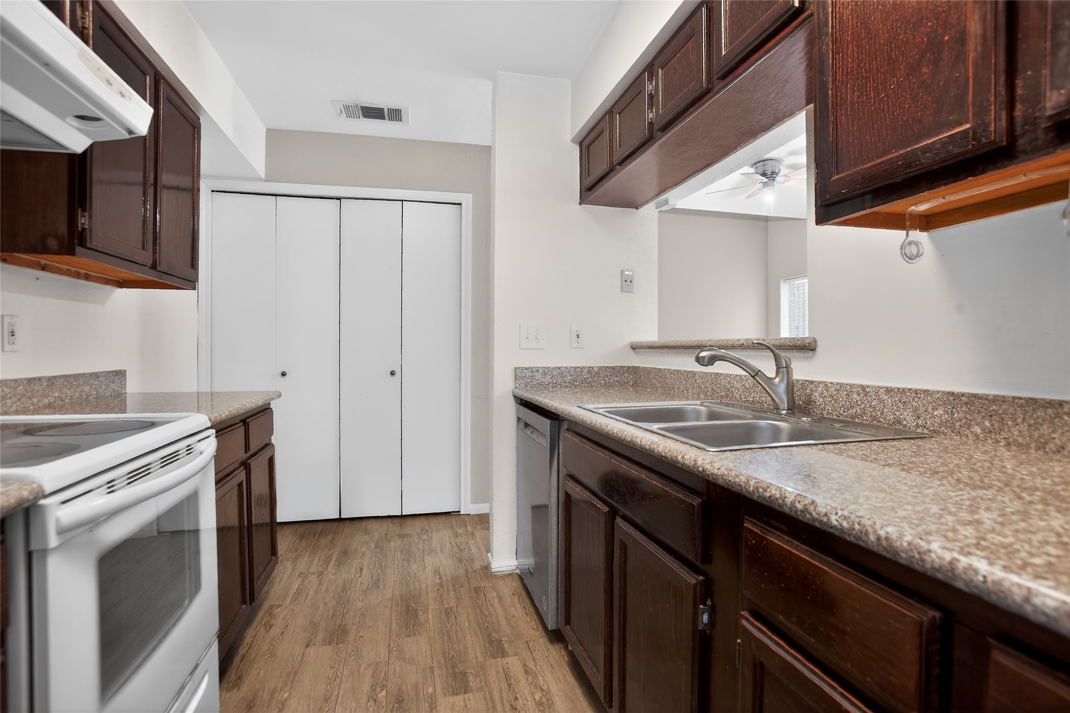 8299 Cambridge Street, Unit 706 Houston, TX 77054 - Photo 6 of 30 a kitchen with stainless steel appliances granite countertop a sink stove and refrigerator