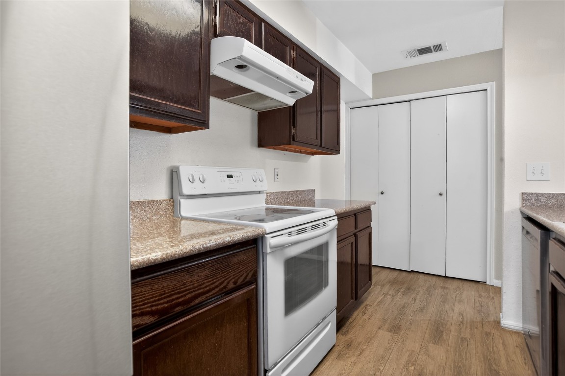8299 Cambridge Street, Unit 706 Houston, TX 77054 - Photo 7 of 30 a kitchen with stainless steel appliances granite countertop a stove and a microwave