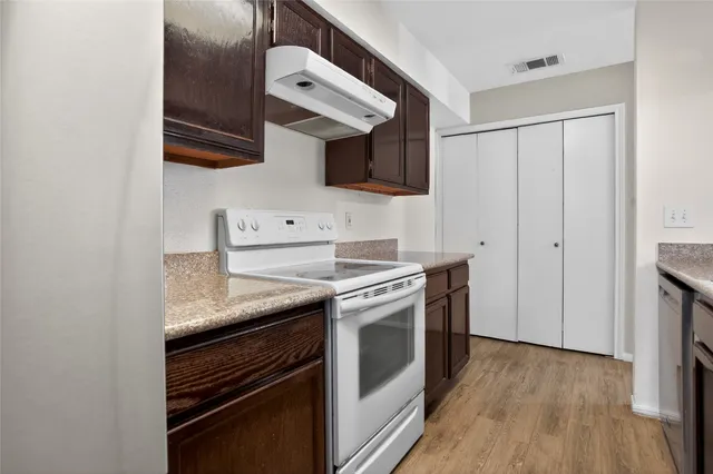 a kitchen with stainless steel appliances granite countertop a stove and a microwave
