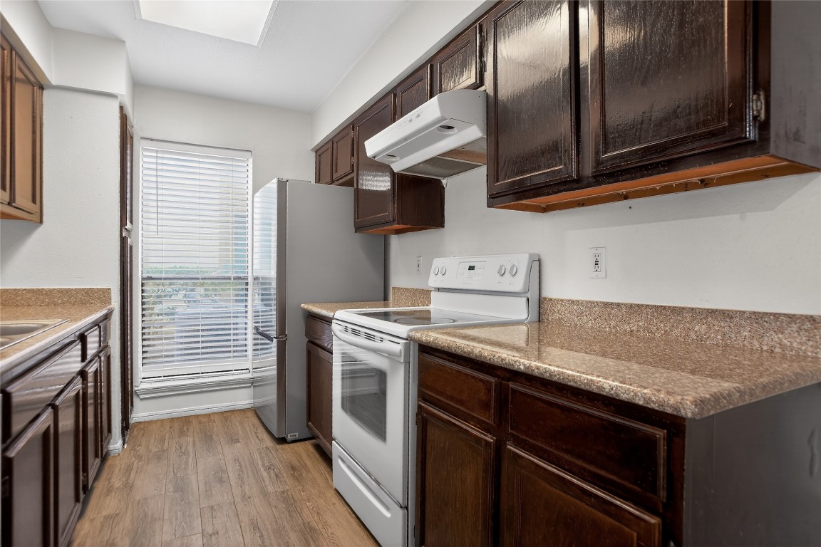 8299 Cambridge Street, Unit 706 Houston, TX 77054 - Photo 10 of 30 a kitchen with stainless steel appliances granite countertop a stove and a microwave