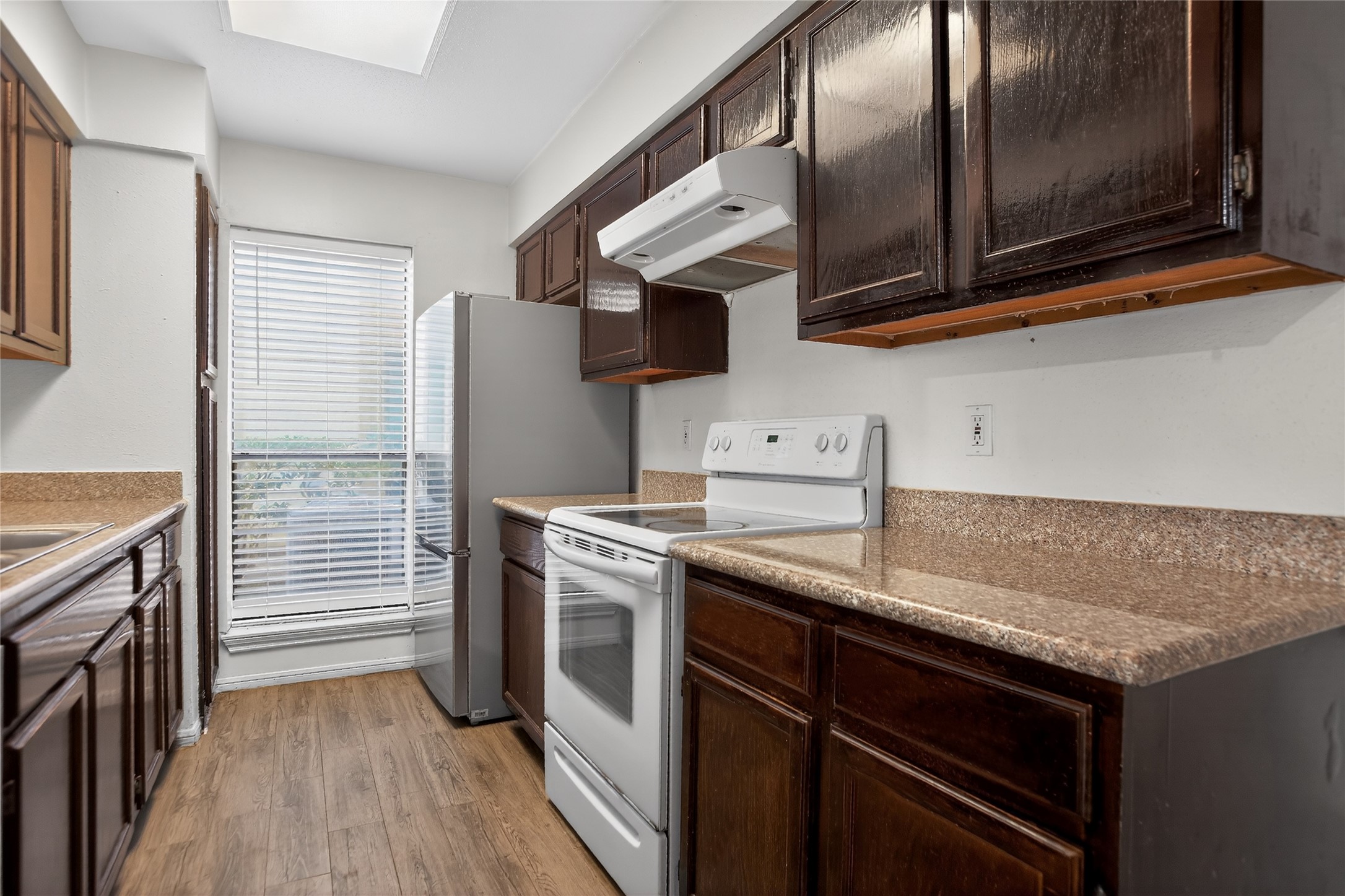 8299 Cambridge Street, Unit 706 Houston, TX 77054 - Photo 10 of 30 a kitchen with stainless steel appliances granite countertop a stove and a microwave