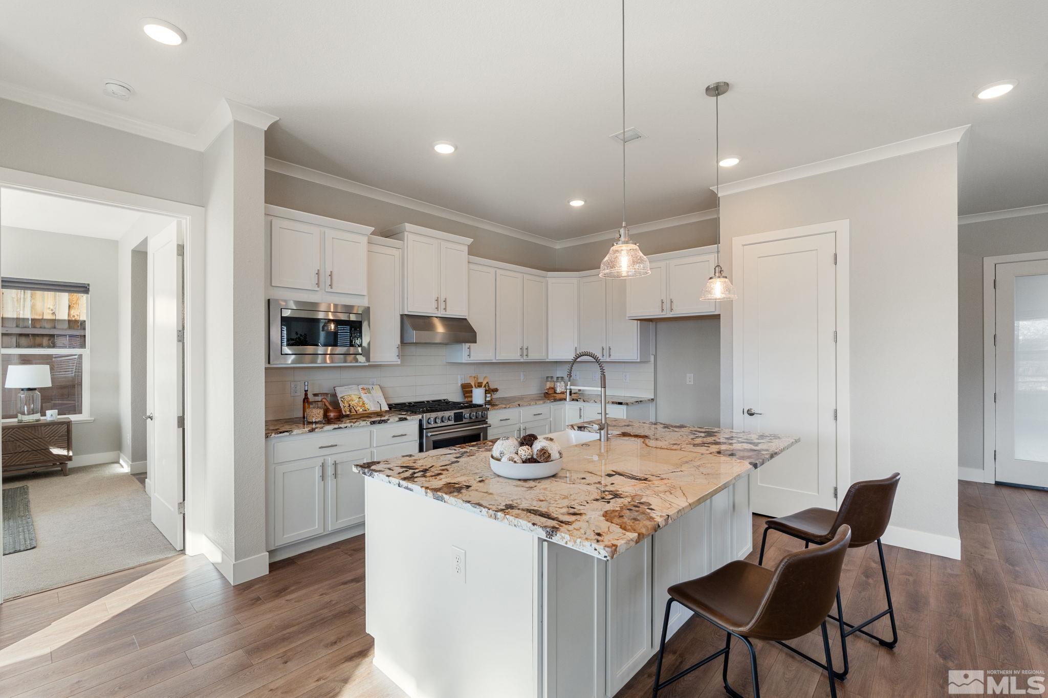 1621 Huntley Trail Reno, NV 89523 - Photo 15 of 40 a kitchen with a stove a refrigerator a sink and a dining table with wooden floor