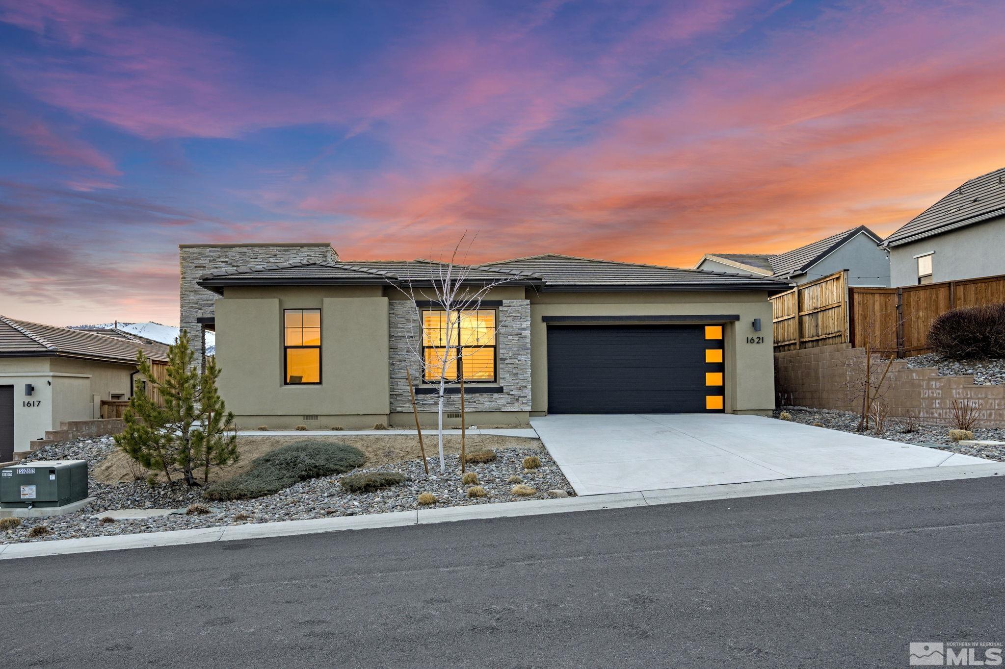1621 Huntley Trail Reno, NV 89523 - Photo 2 of 40 a front view of a house with a yard and garage