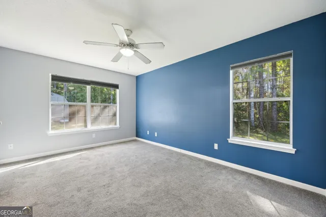 an empty room with windows and closet