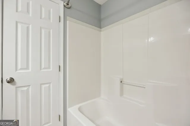 a white bath tub sitting in a bathroom
