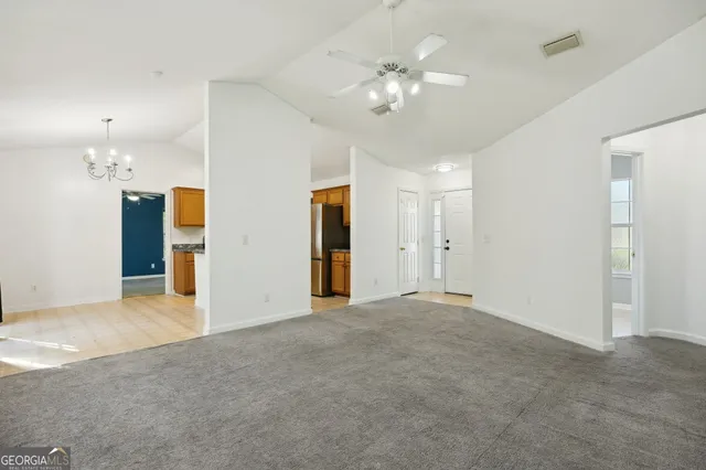 a view of an empty room with a chandelier