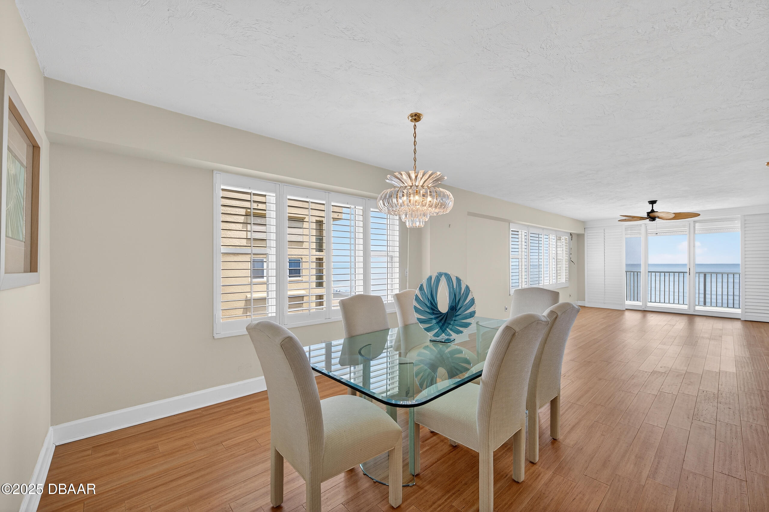 4555 South Atlantic Avenue, Unit 4603 Ponce Inlet, FL 32127 - Photo 11 of 39 a view of a dining room with furniture wooden floor and chandelier