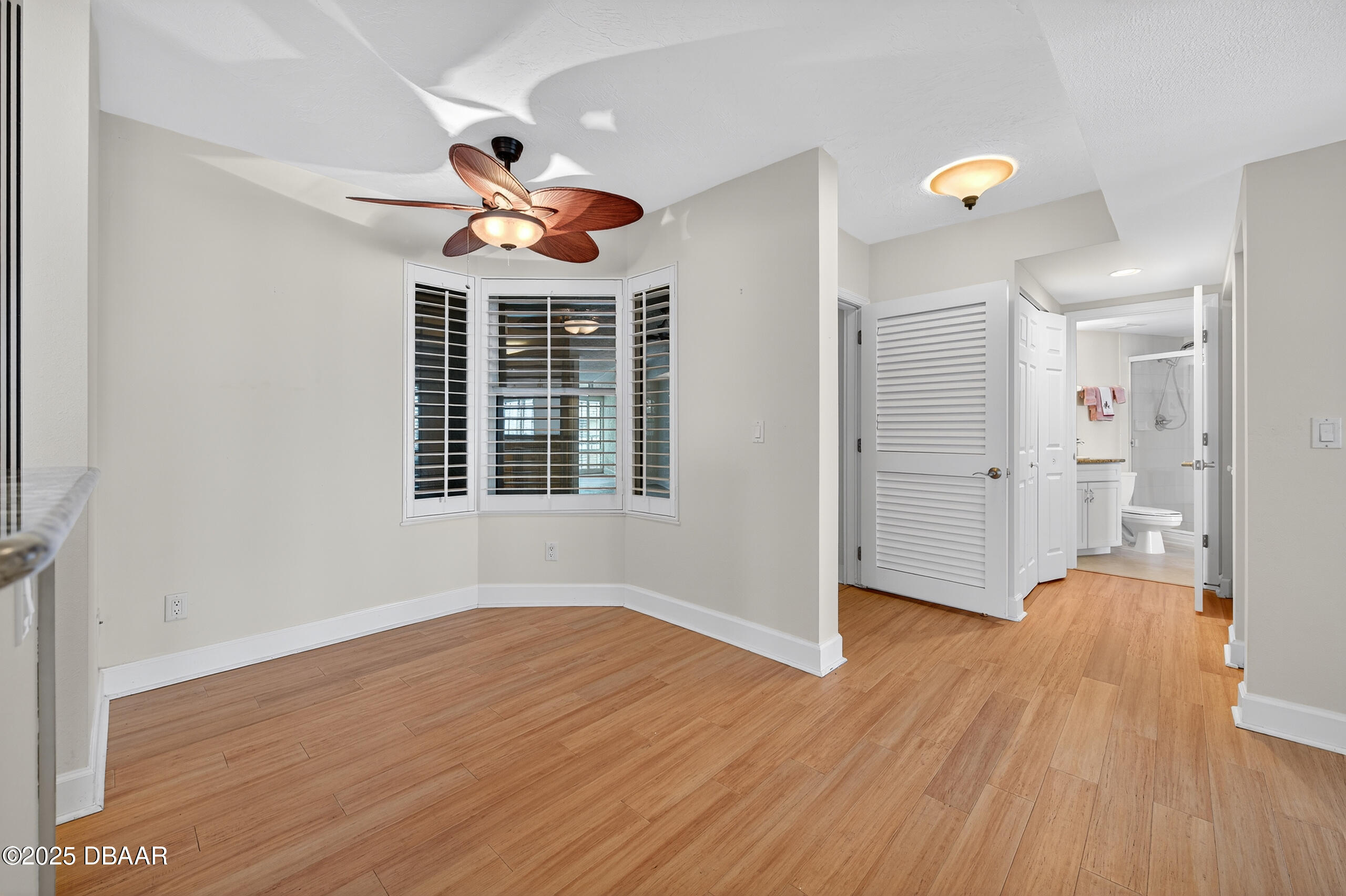 4555 South Atlantic Avenue, Unit 4603 Ponce Inlet, FL 32127 - Photo 22 of 39 a view of an empty room with wooden floor and a window